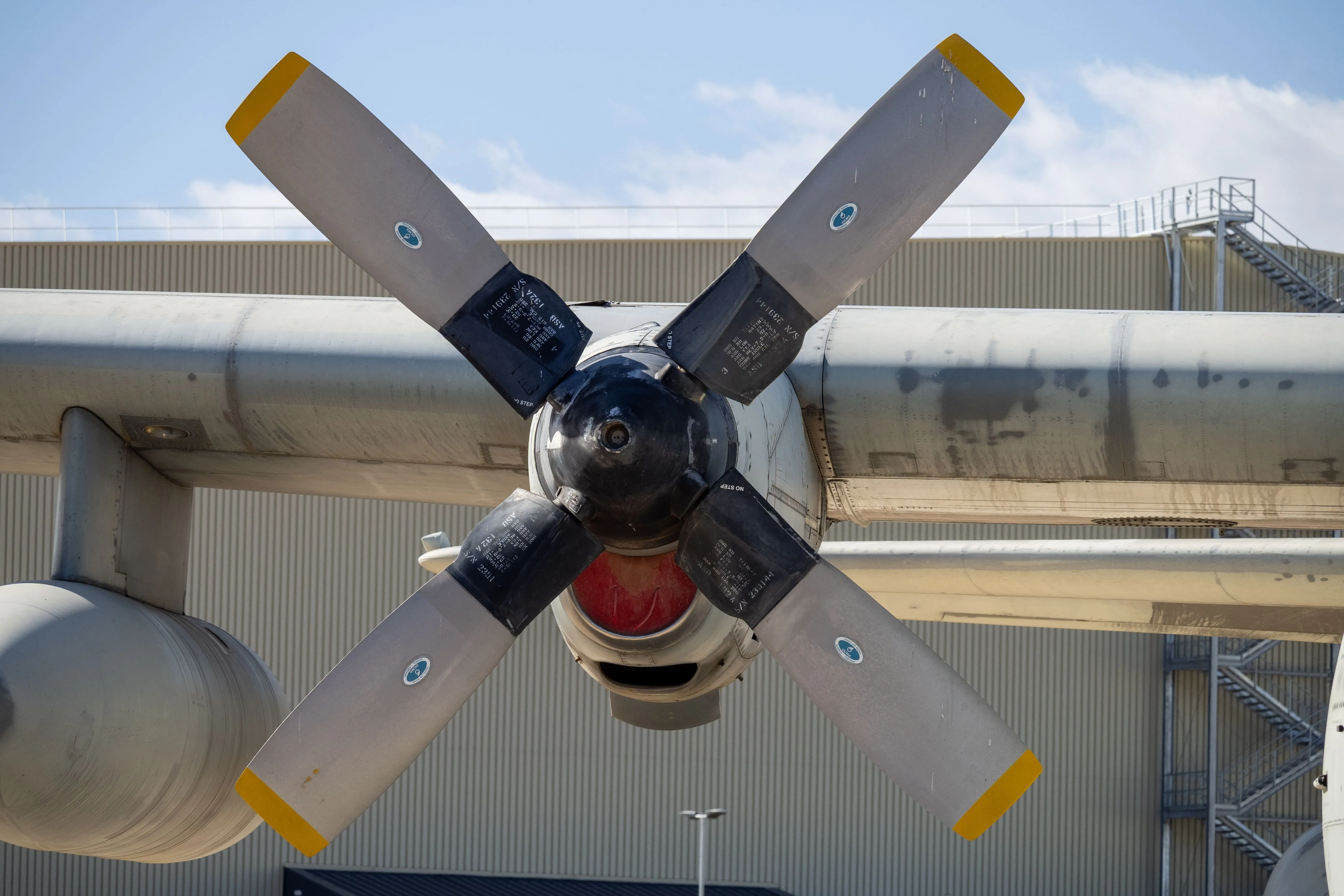 Twin-engine turboprop on a runway at twilight.